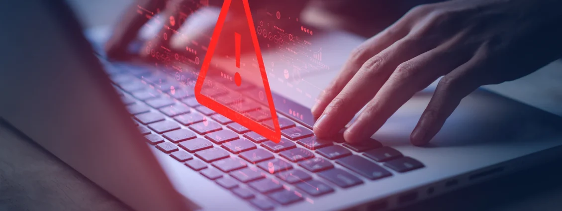 laptop with warning triangle for hacked